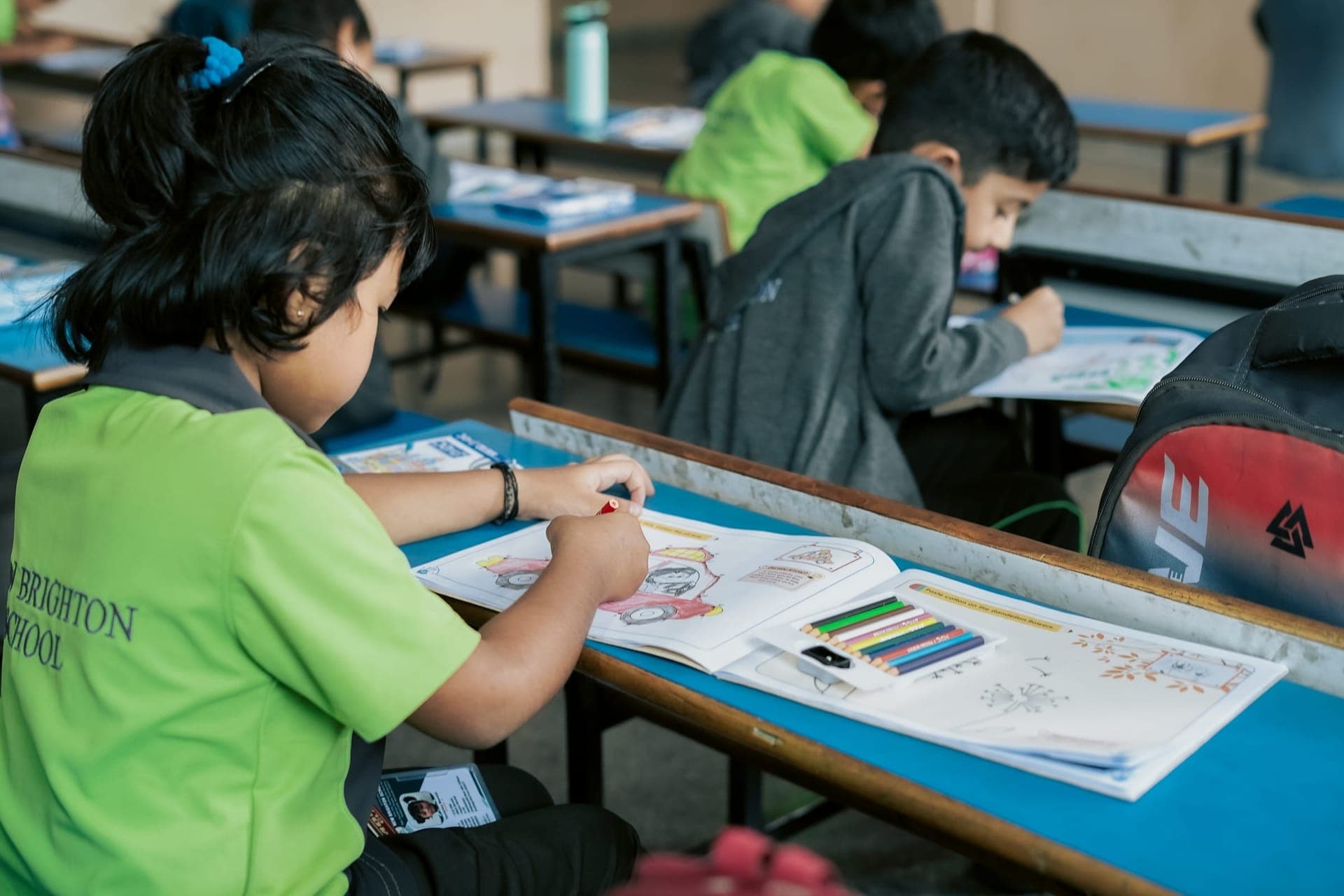 A student working on an art and craft project at their desk
