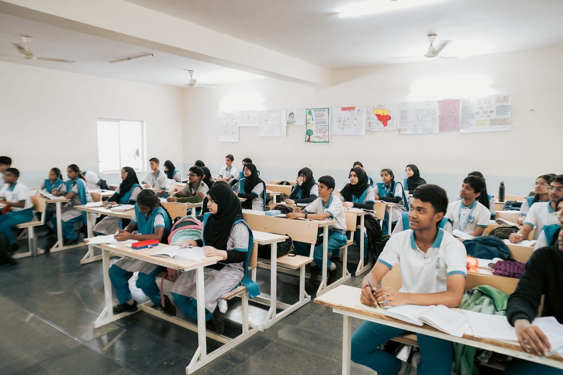 Students at their desks, following a lesson in class